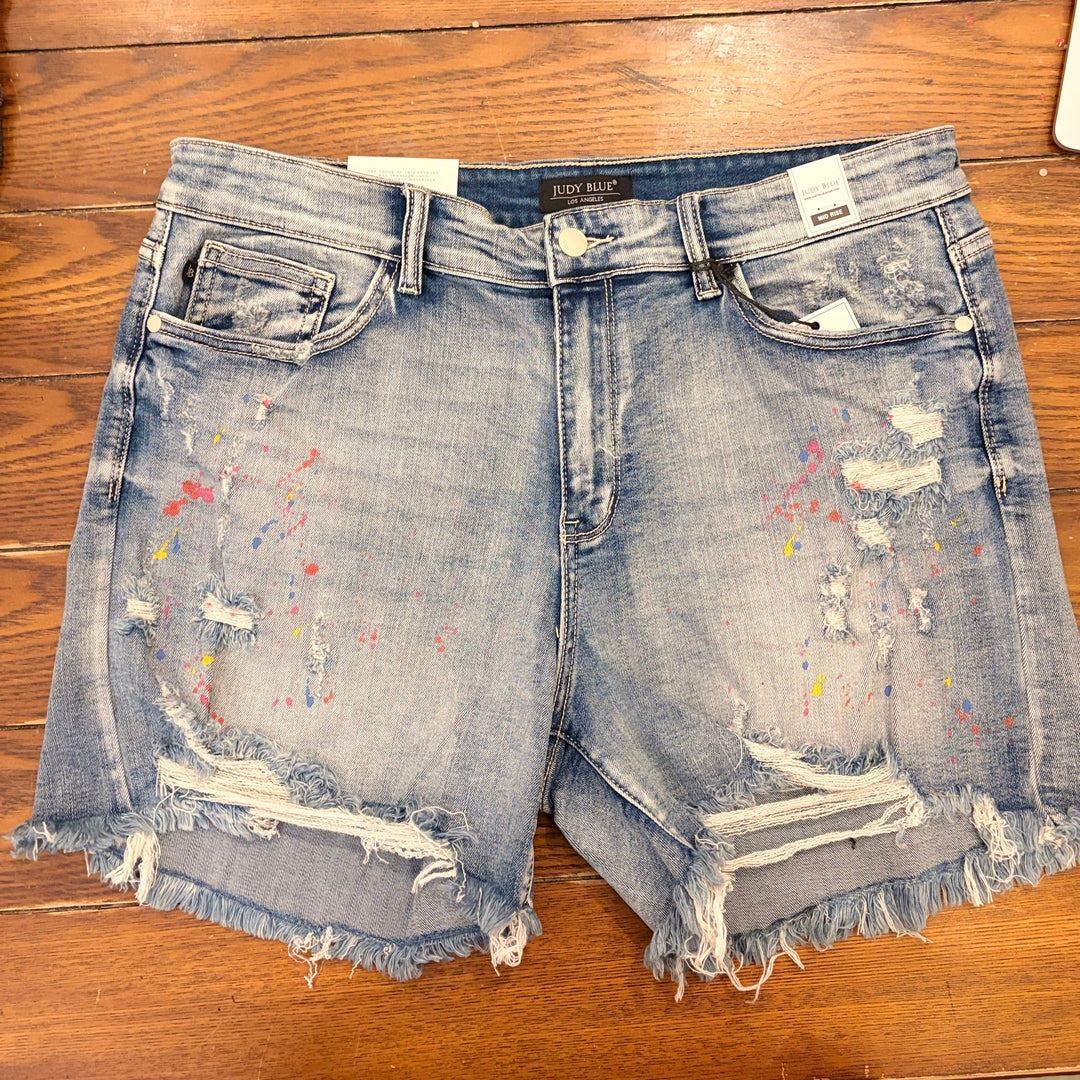 Judy Blue- Mid-Rise Rainbow Paint Splash Cutoff Shorts.