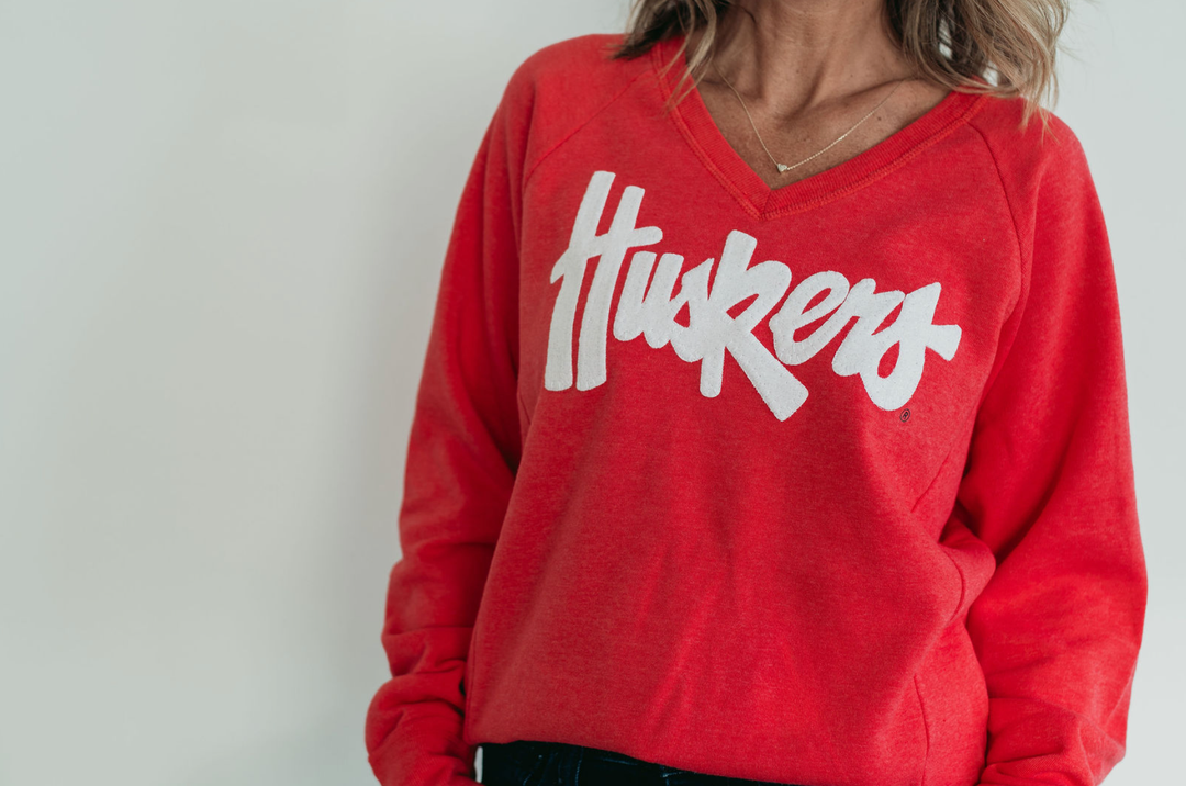 WHITE SPARKLE HUSKERS -  WOMEN'S FLEECE V-NECK - PARADISE RED
